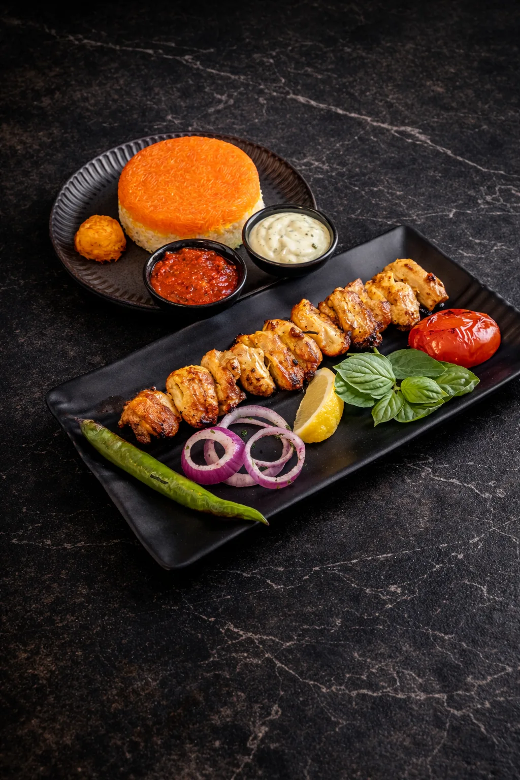 Grilled chicken thigh kebab with rice and condiments