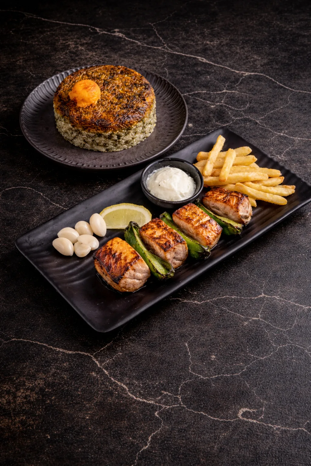 Grilled salmon kebab with herb rice and fries